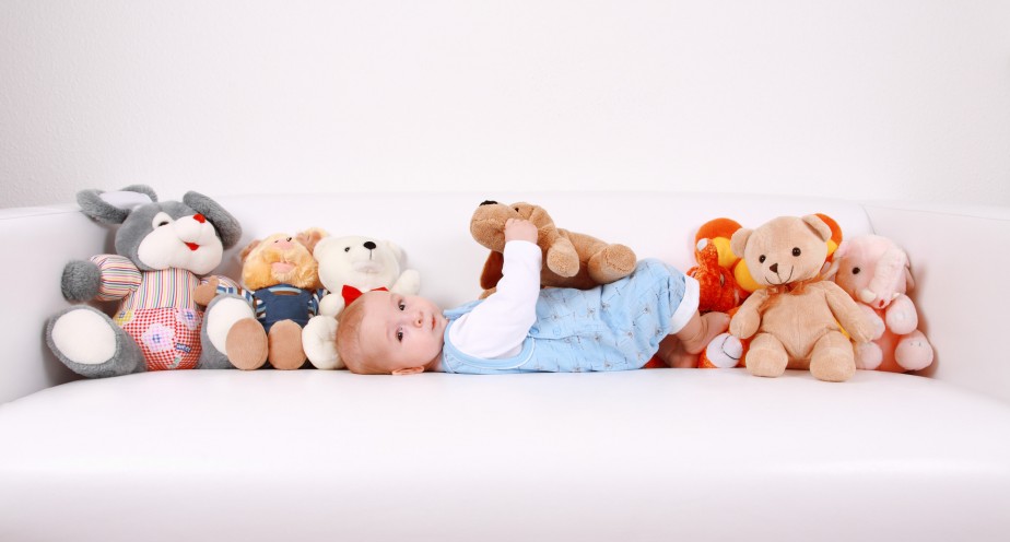 Portrait of cute baby with plenty of toys